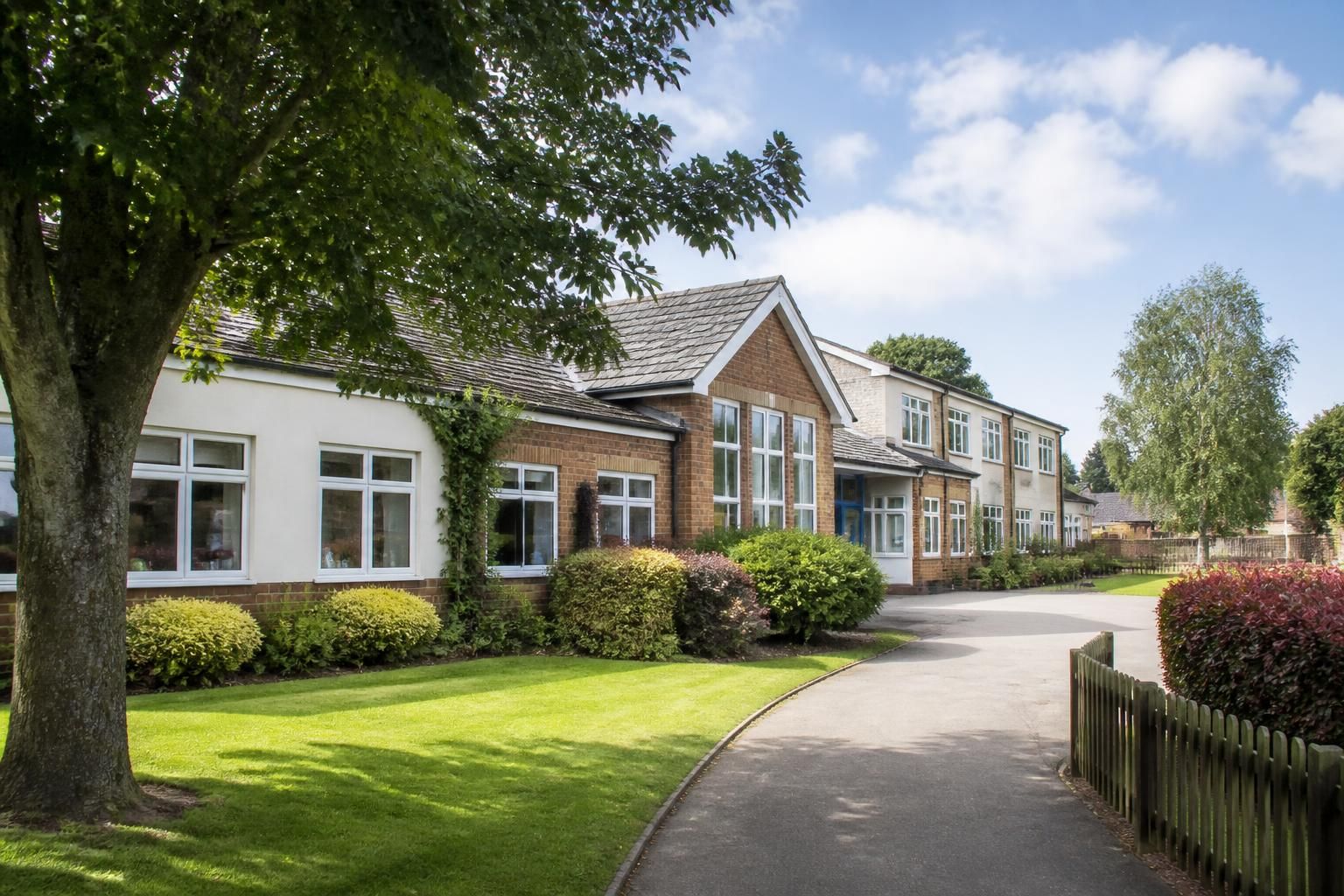 Tidy school building with neatly maintained grounds.